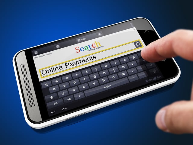 Online Payments in Search String - Finger Presses the Button on Modern Smartphone on Blue Background..jpeg
